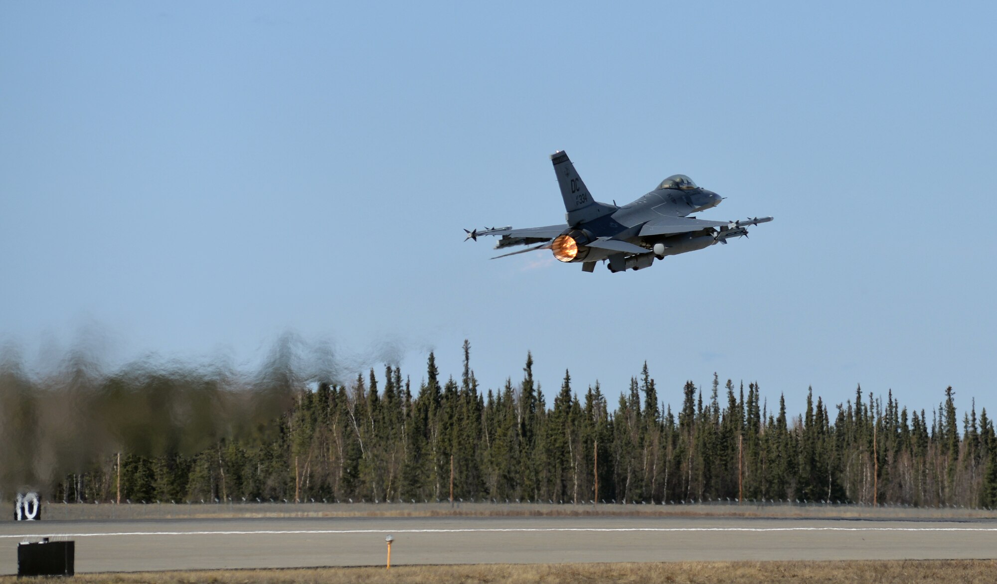 A U.S. Air Force F-16 Fighting Falcon aircraft assigned to the 113th Wing, District of Columbia Air National Guard, takes off from Eielson Air Force Base, Alaska, April 27, 2015, to participate in a Distant Frontier mission with F-16 pilots and aircraft assigned to Eielson's 18th Aggressor Squadron. Distant Frontier provided the deployed pilots an opportunity to fly orientation flights in the more than 67,000 square-mile Joint Pacific Alaska Range Complex, become familiar with local flying restrictions, receive local safety and survival briefings, and develop orientation plans during the week prior to RED FLAG-Alaska 15-2, a Pacific Air Forces-directed field training exercise flown under simulated air combat conditions to increases combat capability. (U.S. Air Force photo by Master Sgt. Karen J. Tomasik/Released)