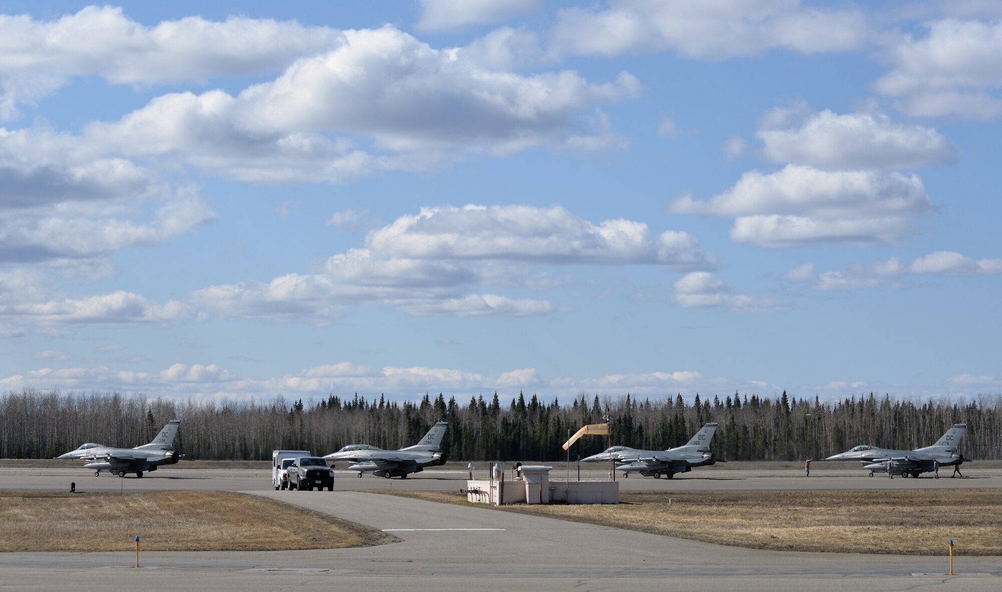 U.S. Air Force F-16 Fighting Falcon aircraft assigned to the 113th Wing, District of Columbia Air National Guard, wait to take off from Eielson Air Force Base, Alaska, April 27, 2015, to participate in a Distant Frontier mission with F-16 pilots and aircraft assigned to Eielson's 18th Aggressor Squadron. Distant Frontier provided the deployed pilots an opportunity to fly orientation flights in the more than 67,000 square-mile Joint Pacific Alaska Range Complex, become familiar with local flying restrictions, receive local safety and survival briefings, and develop orientation plans during the week prior to RED FLAG-Alaska 15-2, a Pacific Air Forces-directed field training exercise flown under simulated air combat conditions to increases combat capability. (U.S. Air Force photo by Master Sgt. Karen J. Tomasik/Released)