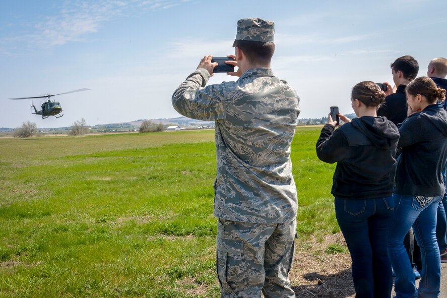A 36th Rescue Flight UH-1N Iroquois helicopter shows off their capabilities to Washington State University Air Force ROTC cadets during their tour of the base May 1, 2015, at Fairchild Air Force Base, Wash. Students were given a chance to see and explore not only the main part of the base, but also what the Survival, Evasion, Resistance and Escape School teaches students going through the training. (U.S. Air Force photo/Senior Airman Janelle Patiño)