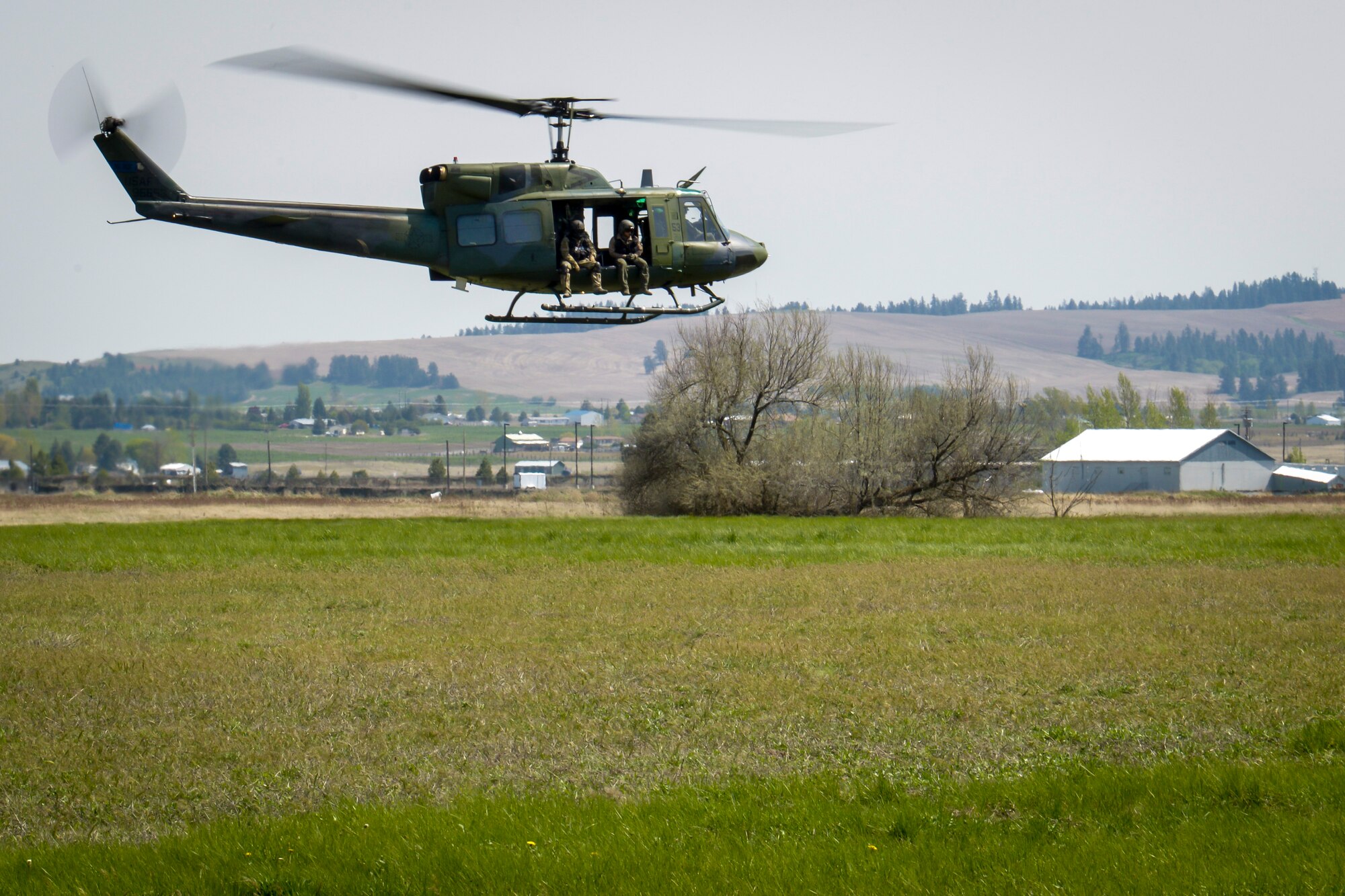A 36th Rescue Flight UH-1N Iroquois helicopter shows off their capabilities to Washington State University Air Force ROTC cadets during their tour of the base May 1, 2015, at Fairchild Air Force Base, Wash. Students were given a chance to see and explore not only the main part of the base, but also what the Survival, Evasion, Resistance and Escape School teaches students going through the training. (U.S. Air Force photo/Senior Airman Janelle Patiño)