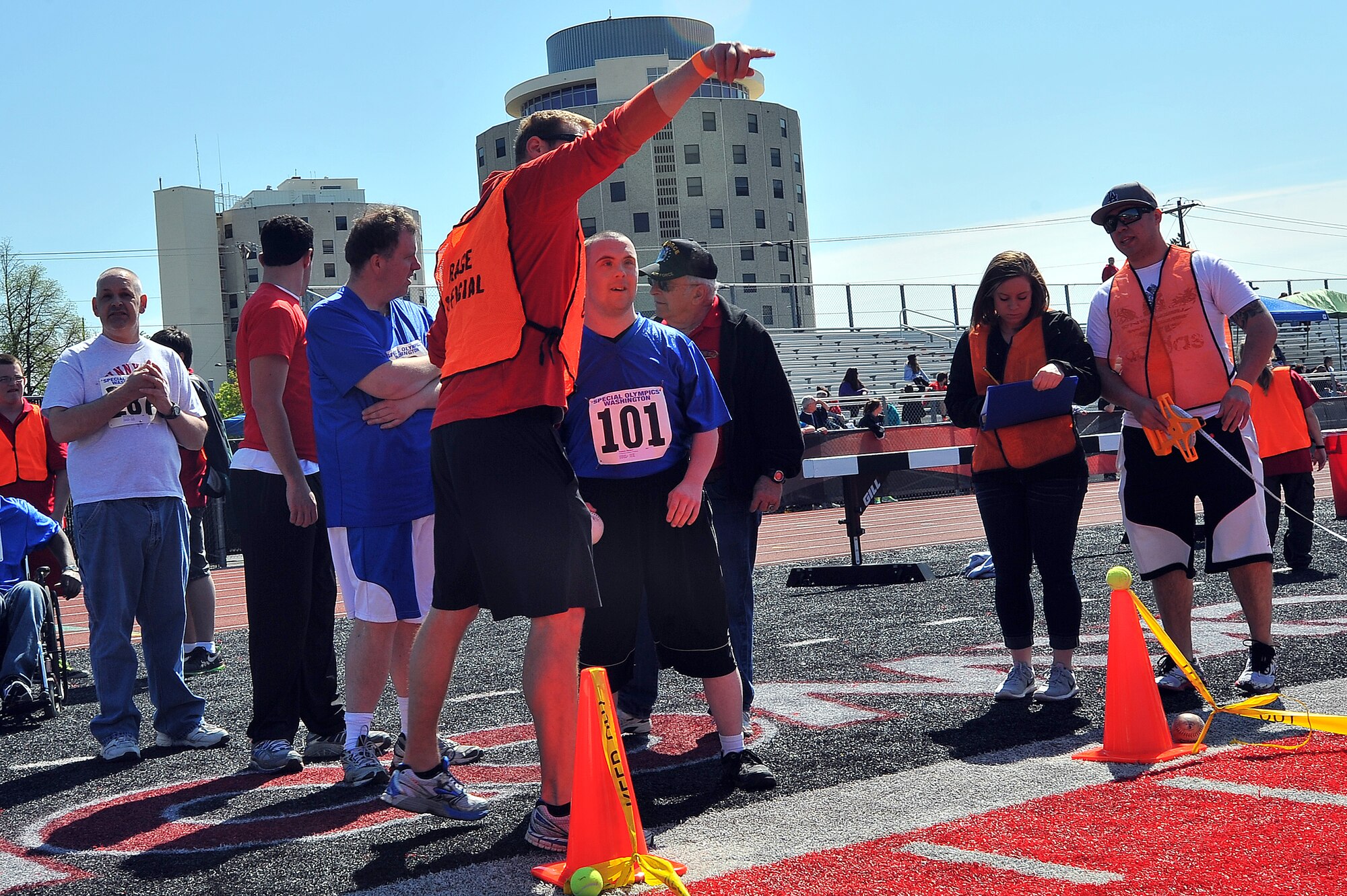 Maj. Matt Arnold, 66th Training Squadron combat rescue officer, shows Matthew Yeaman, a Community Colleges of Spokane participant, how to aim the tennis ball during the Spring Special Olympics May 2, 2015, in Cheney, Wash. Nearly 800 athletes from across eastern Washington participated in the Special Olympic Spring Games held at Eastern Washington University. (U.S. Air Force photo/Staff Sgt. Veronica Montes)