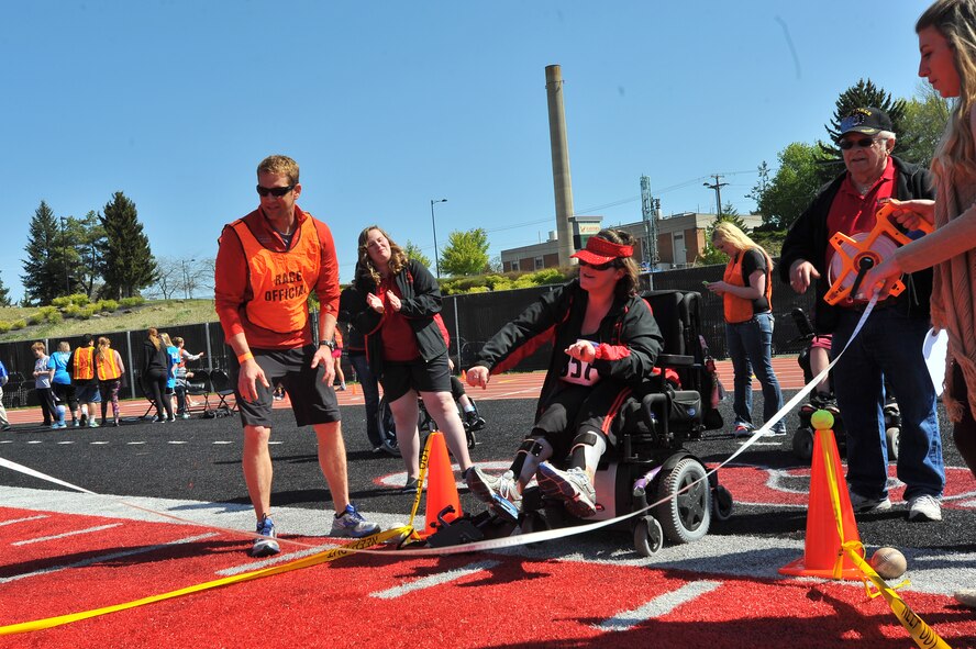 Maj. Matt Arnold, 66th Training Squadron combat rescue officer, looks on as Letisha O’Farrell, Twin River Lightning Bolts participant, throws a softball during the Spring Special Olympics May 2, 2015, in Cheney, Wash. The mission of Special Olympics is to provide year-round sports training and athletic competition in a variety of Olympic-type sports for children and adults with intellectual disabilities, giving them continuing opportunities to develop physical fitness, demonstrate courage, experience joy and participate in a sharing of gifts, skills and friendship with their families, other Special Olympics athletes and the community. (U.S. Air Force photo/Staff Sgt. Veronica Montes)