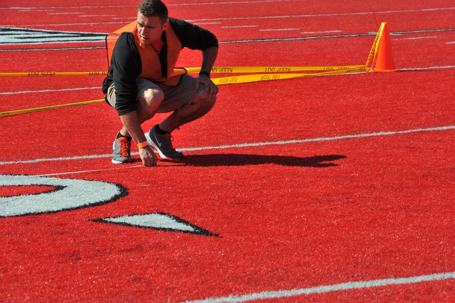 Airman 1st Class Branden Berns, 92nd Logistics Readiness Squadron vehicle maintenance and analysis specialist, measures the length of a throw at the softball throw event during the Spring Special Olympics May 2, 2015, in Cheney, Wash. Nearly 800 athletes from across eastern Washington participated in the Special Olympic Spring Games held at Eastern Washington University. (U.S. Air Force photo/Staff Sgt. Veronica Montes)