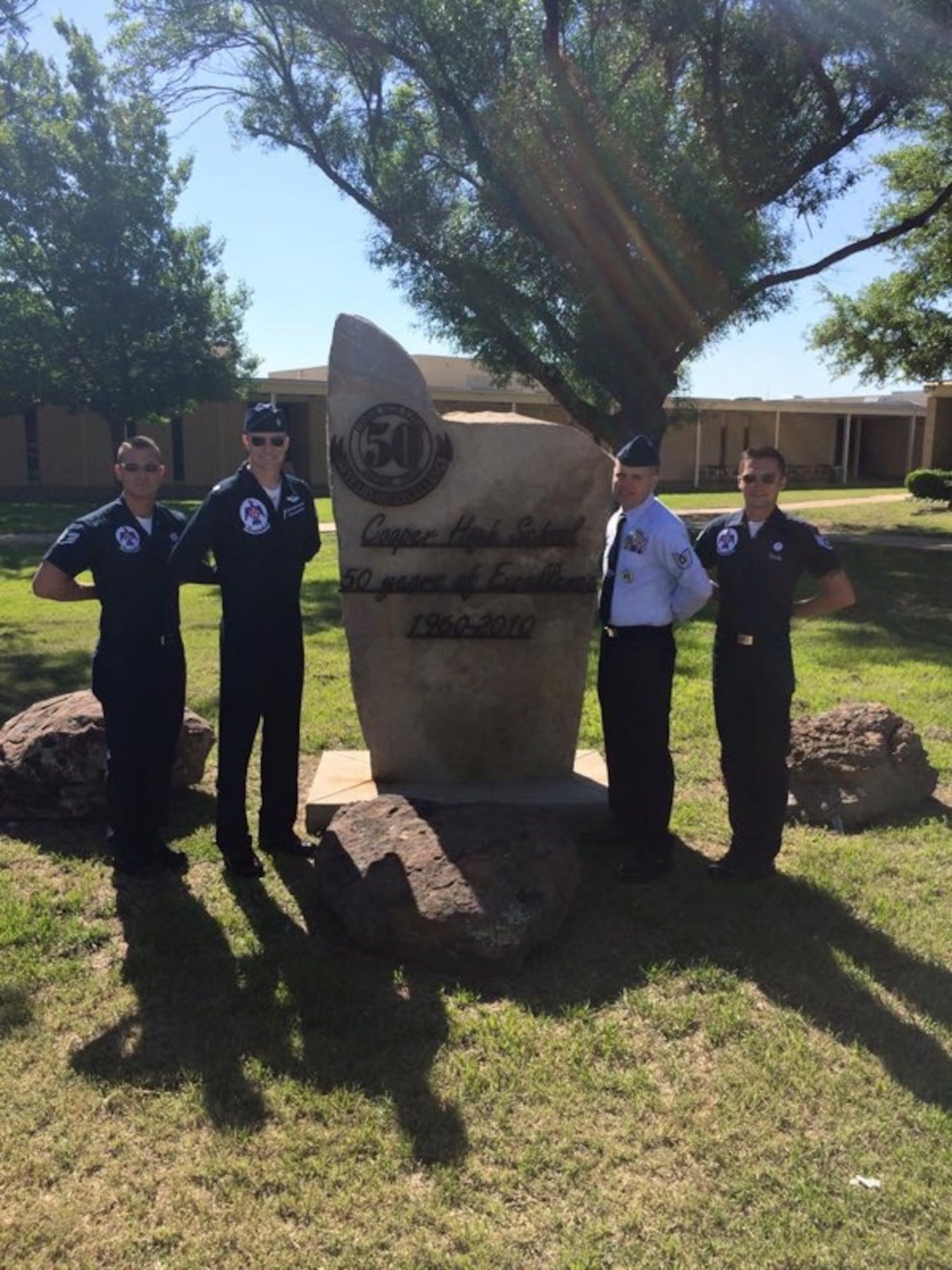 U.S. Air Force Thunderbird No. 1, Lt. Col. Christopher Hammond, second from left, poses in front of Cooper High School May 1, 2015, in Abilene, Texas. Hammond, a 1994 Cooper High School graduate, spent the day talking to students about his life growing up and his Air Force career. He and the Thunderbird team participated in the 2015 Dyess Big Country Airfest May 2-3. (U.S. Air Force photo by Staff Sgt. Joel Mease/Released)