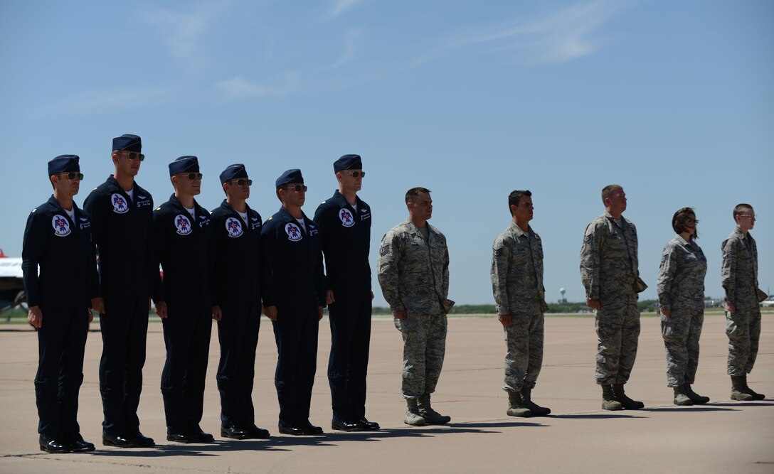 The U.S. Air Force Thunderbirds’ air demonstration team poses with Dyess Airmen May 3, 2015, at Dyess Air Force Base, Texas. The Airmen were recognized in front of 8,000 spectators during the 2015 Dyess Big Country Airfest for their great work ethic within their career fields. (U.S. Air Force photo by Airman 1st Class Kedesha Pennant/Released)