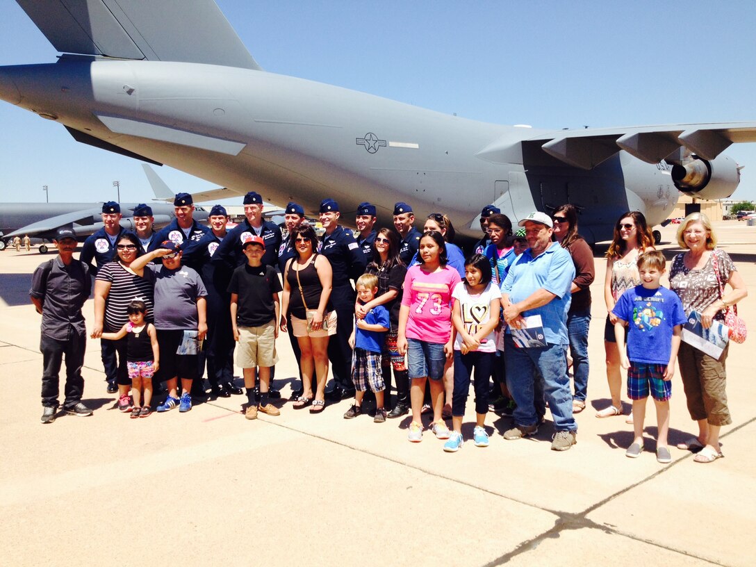 The U.S. Air Force Thunderbirds pose for a photo with children and their families from the Make-A-Wish Program May 1, 2015, at Dyess Air Force Base, Texas. The children spent time talking with the Thunderbirds, getting autographs, and taking photos during a practice show opened only to Make-A-Wish families. (U.S. Air Force photo by Staff Sgt. Joel Mease/Released)