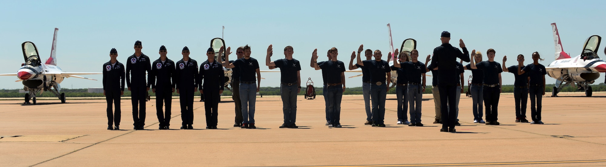 U.S. Air Force Thunderbird No. 1, Lt. Col. Christopher Hammond, issues the oath of enlistment to Air Force recruits May 2, 2015, at Dyess Air Force Base, Texas. The oath of enlistment was issued during the 2015 Dyess Big Country Airfest in front of a crowd of more than 18,000 people. These men and women will be attending basic training upon graduating from high school. (U.S. Air Force photo by Airman 1st Class Autumn Velez/Released)