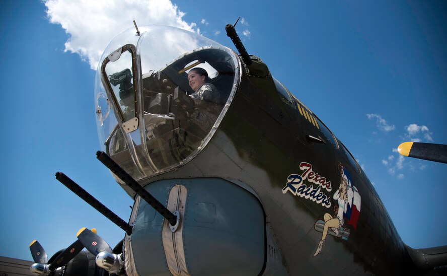 Senior Airman Aubrey Daley, 89th Airlift Wing command chief executive assistant, sits in the bombardier’s seat of the B-17G Texas Raiders at Joint Base Andrews, Md., May 4, 2015. The B-17 was here with the Commemorative Air Force organization to educate JBA members of the value of military aviation. (U.S. Air Force photo/Airman 1st Class Philip Bryant)