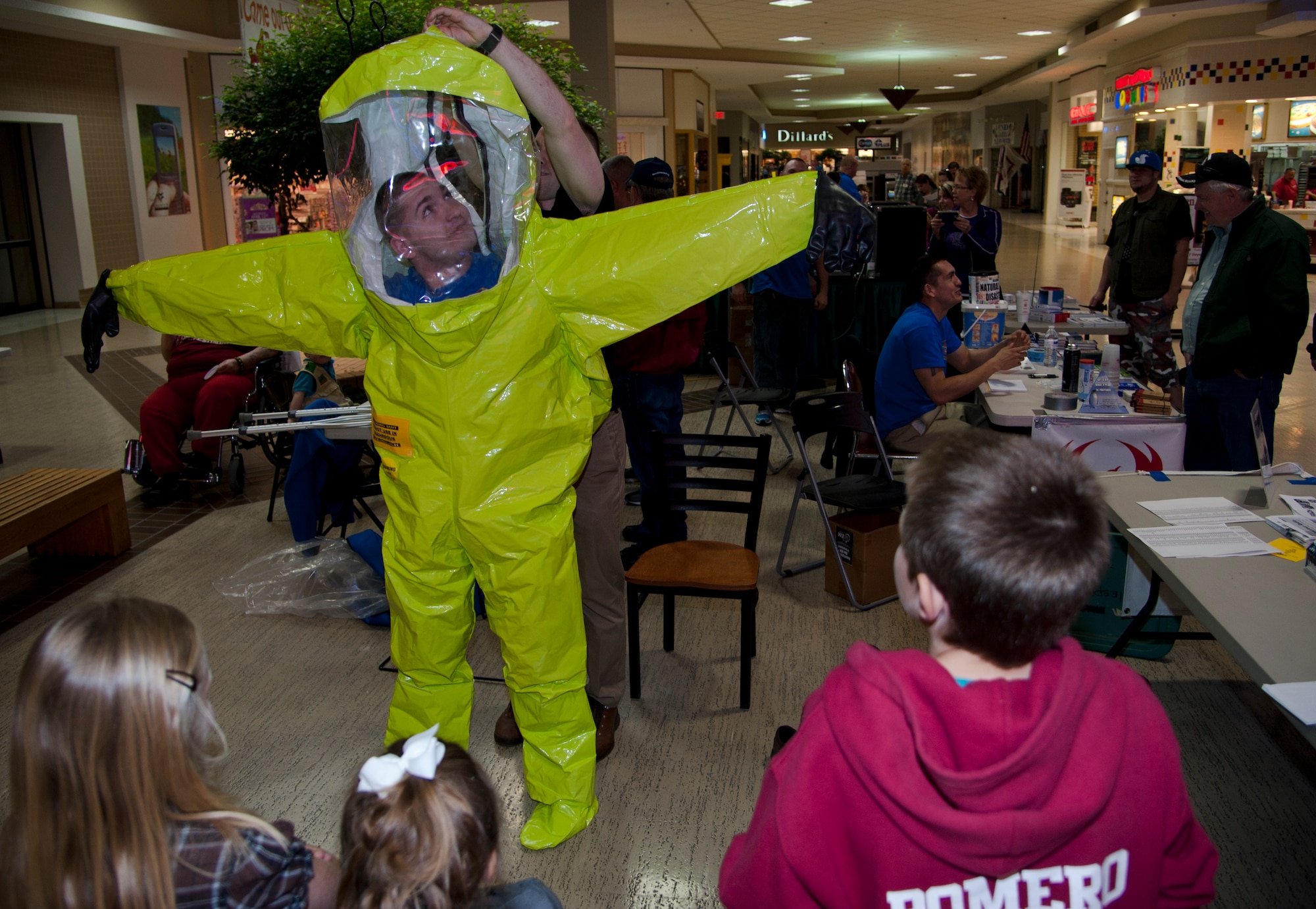 Senior Airman Zachary Paskovitch, a 71st Logistics Readiness Squadron Emergency Management Flight emergency management journeyman, dons a hazmat suit during the 4th Annual Weather and Disaster Preparedness Day April 8 at the Oakwood Mall in Enid, Oklahoma. The Airmen joined emergency management personnel from across Garfield County to hand out preparedness information to the local community. (U.S. Air Force Photo/Staff Sgt. Nancy Falcon)
