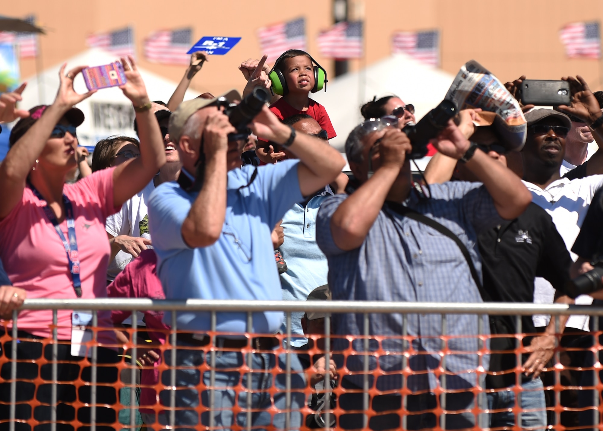 A crowd of spectators watch the U.S. Air Force Thunderbirds as they perform, May 2, 2015, at Dyess Air Force Base, Texas. During the 2015 Dyess Big Country Airfest, more than 26,000 people came to watch acts such as The Wings of Blue, the U.S. Army Golden Knights and a joint force close air support exposition between B-1B Lancer, a UH-60A Blackhawk and an AH-64 Apache. (U.S. Air Force photo by Airman 1sr Class Alexander Guerrero/Released)