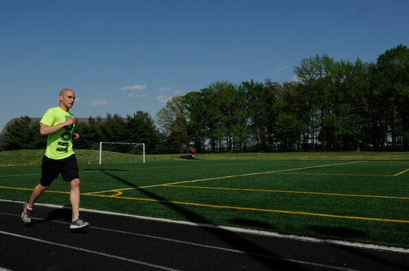 Airman 1st Class Joshua Islas, 11th Wing Staff Agency administrative technician, runs on the track at Joint Base Andrews, Md., May 4, 2015. Islas has competed in two marathons, three half marathons, an 18 mile race and other races of shorter distances. (U.S. Air Force photo by Senior Airman Mariah Haddenham)