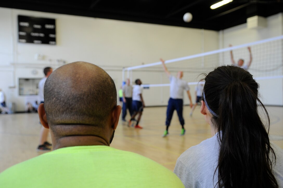 Members of Joint Base Andrews watch their team play volleyball during Wingman Day here, May 5, 2015. (U.S. Air Force photo by Senior Airman Mariah Haddenham)