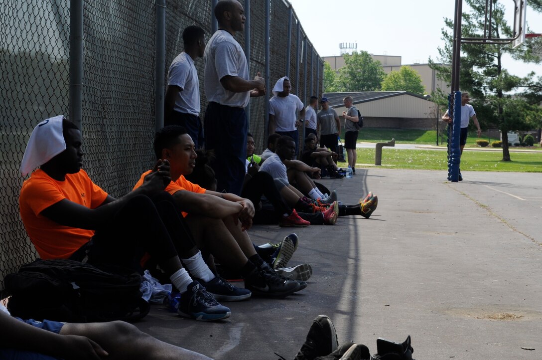 Members of Joint Base Andrews relax in the shade after a basketball game during Wingman Day here, May 5, 2015. Activities included a tactical fitness competition, volleyball, basketball, soccer, softball and a video game tournament. (U.S. Air Force photo by Senior Airman Mariah Haddenham)