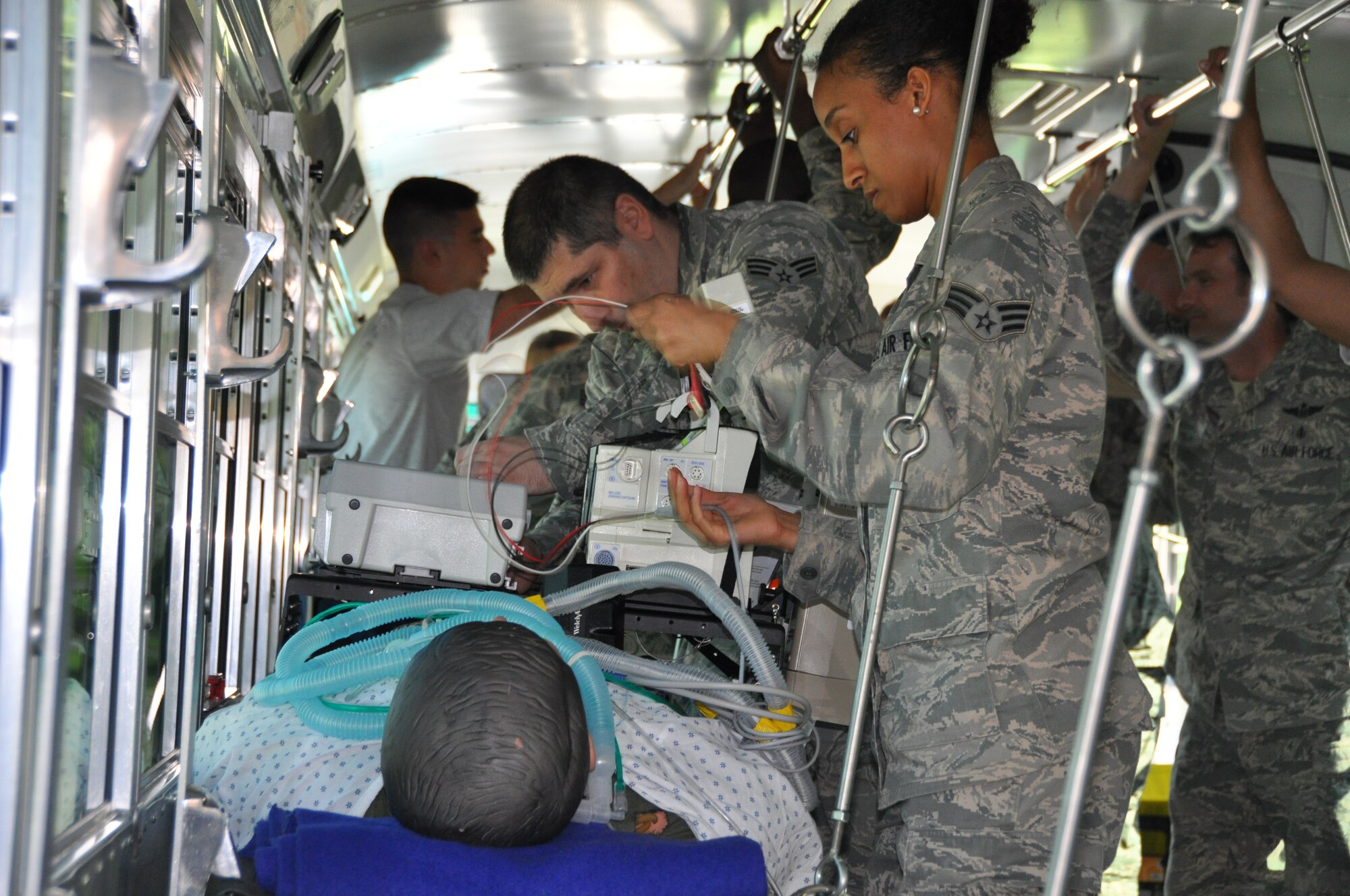 Senior Airman Gabriel Sandu and Senior Airman Jasmine Simms, both cardiopulmonary lab specialists, work diligently to insure a critical condition patient receives the proper medical attention on transit to the aerial evacuation. The exercise mimicked emergency medical situation in the event of a disaster at Joint Base Andrews on Monday, May 4, 2015 (Air Force Photo / Senior Airman Kristin Kurtz)