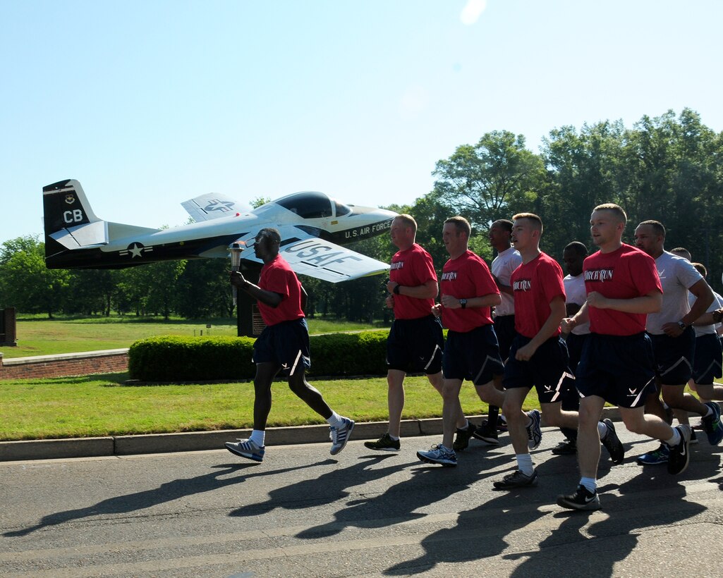 Airmen from the 14th Security Forces Squadron participate in the 2015 Law Enforcement Torch Run for Special Olympics May 5 on Columbus Air Force Base, Mississippi to honor the athletes of the Special Olympics. Law enforcement officers from around the world have gathered annually since 1987 to carry the Flame of Hope in a Law Enforcement Torch Run Final Leg in conjunction with Special Olympics and World Winter Games. Annual fundraising efforts raise funds so more Special Olympics athletes can benefit in many areas of their lives through sports training and competition. (U.S. Air Force Photo/Elizabeth Owens)