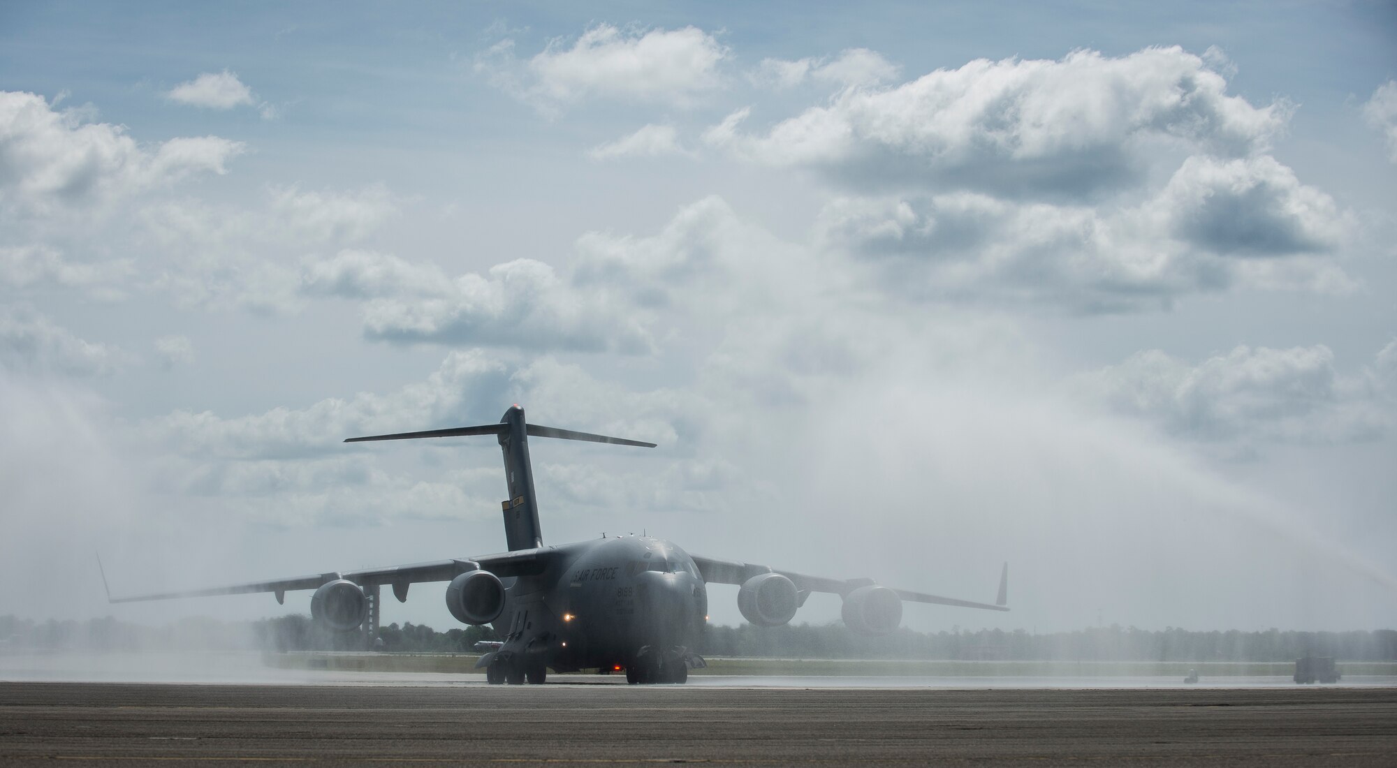 A C-17 Globemaster III assigned to the 437th Airlift Wing and the 315th Airlift Wing is sprayed with water May 5, 2015 at Joint Base Charleston, S.C., during an event celebrating the C-17 surpassing the three millionth flying hour.  Aircrew members from JB Charleston flew the plane here from Robins Air Force Base, Ga. The first C-17 flight was Sept. 15, 1991 and the Air Force currently has 222 C-17’s in the fleet. (U.S. Air Force photo/Senior Airman Jared Trimarchi) 