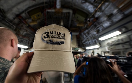 An Airman holds up a hat aboard a C-17 Globemaster III May 5, 2015 at Joint Base Charleston, S.C, during an event celebrating the C-17 surpassing the three millionth flying hour.  An aircrew from JB Charleston flew the plane here from Robins Air Force Base, Ga. The first C-17 flight was Sept. 15, 1991 and the Air Force currently has 222 C-17’s in the fleet. (U.S. Air Force photo/Senior Airman Jared Trimarchi) 