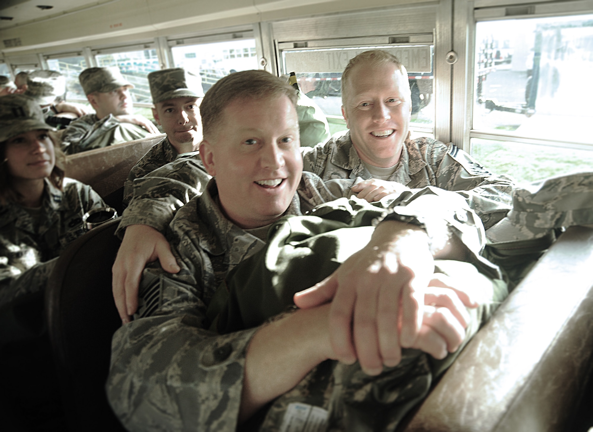 Airmen from the Oregon Air National Guard enjoy a lighter moment during the bus ride to the AEF Skill Rodeo training area, April 12, 2015, Portland Air National Guard Base, Ore. (U.S. Air National Guard photo by Tech. Sgt. John Hughel, 142nd Fighter Wing Public Affairs/Release)