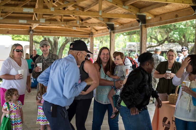 Attendees dance to live music during the annual base picnic May 1, 2015 at Joint Base Charleston, S.C. The two-day event included free food, live music, an inflatable obstacle course, a rock-climbing wall, a military working dog demo, prizes and demonstrations from local organizations. These organizations support service members throughout the year. (U.S. Air Force photo/Senior Airman Jared Trimarchi) 