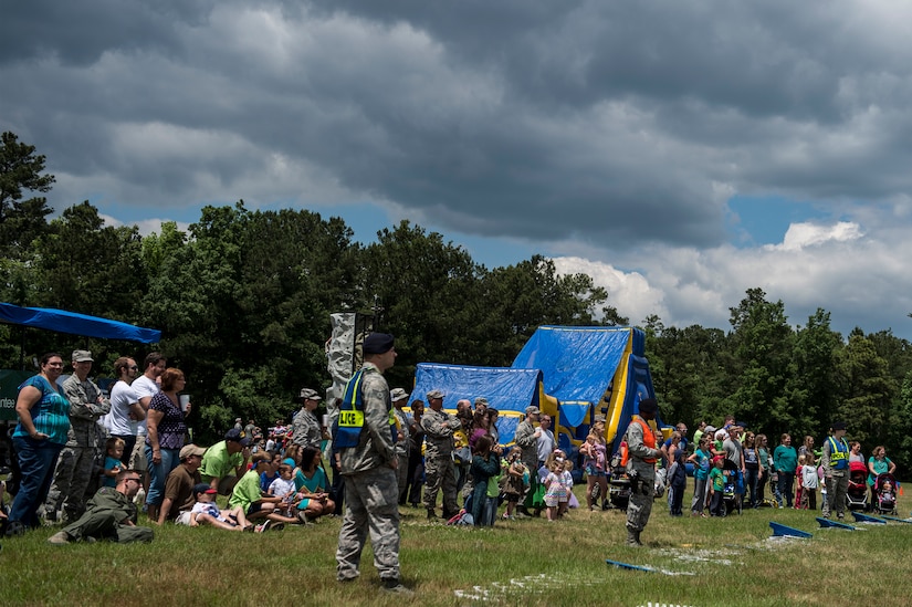 A crowd awaits the start to a military working dog demo during the annual base picnic May 1, 2015 at Joint Base Charleston, S.C. The two-day event included free food, live music, an inflatable obstacle course, a rock-climbing wall, a military working dog demo, prizes and demonstrations from local organizations. These organizations support service members throughout the year. (U.S. Air Force photo/Senior Airman Jared Trimarchi) 