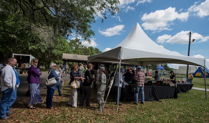 A line forms at the food tent during the annual base picnic May 1, 2015 at Joint Base Charleston, S.C. The two-day event included free food, live music, an inflatable obstacle course, a rock-climbing wall, a military working dog demo, prizes and demonstrations from local organizations. These organizations support service members throughout the year. (U.S. Air Force photo/Senior Airman Jared Trimarchi) 