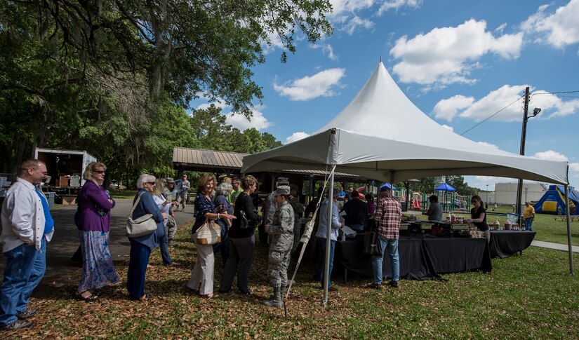 A line forms at the food tent during the annual base picnic May 1, 2015 at Joint Base Charleston, S.C. The two-day event included free food, live music, an inflatable obstacle course, a rock-climbing wall, a military working dog demo, prizes and demonstrations from local organizations. These organizations support service members throughout the year. (U.S. Air Force photo/Senior Airman Jared Trimarchi) 
