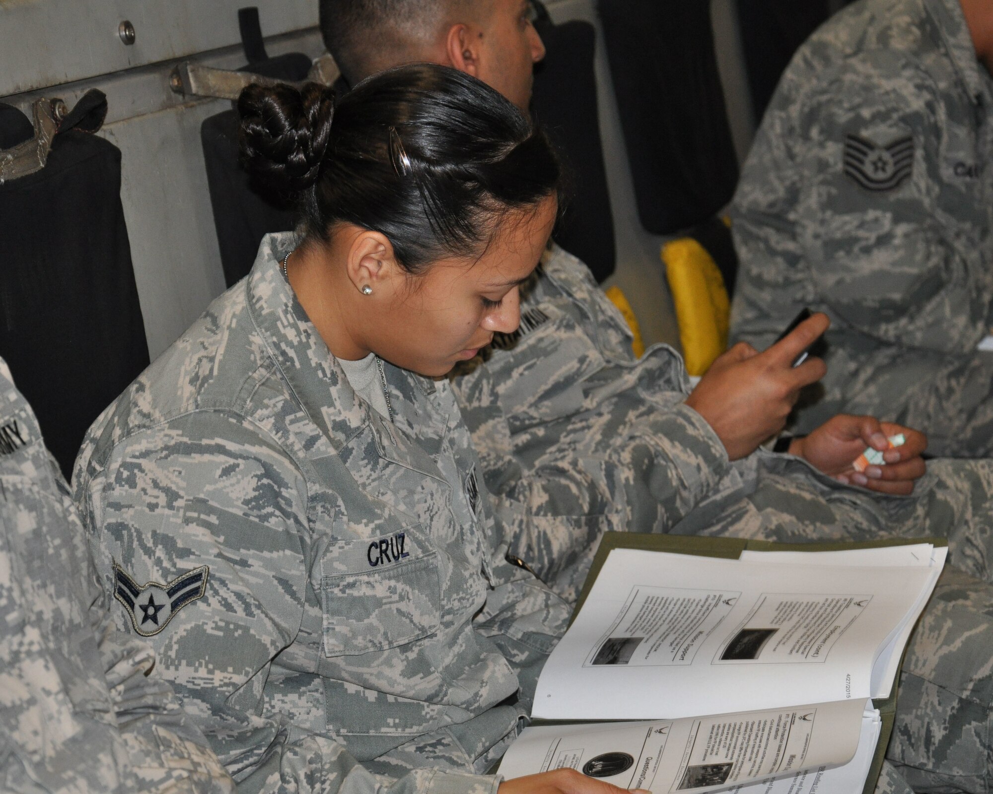 U.S. Air Force Airman 1st Class Hania Cruz, Pacific Air Forces communications specialist, reviews mission briefing prior to departing Joint Base Pearl Harbor-Hickam, Hawaii, May 1, 2015. Cruz, originally from West Palm Beach, Fla., is part of the Joint Air Component Coordination Element team sent to Uda Pao, Thailand to support the U.S. Agency for International Development's operations in Nepal. (U.S. Air Force photo by Maj. Ashley Conner/Released)
