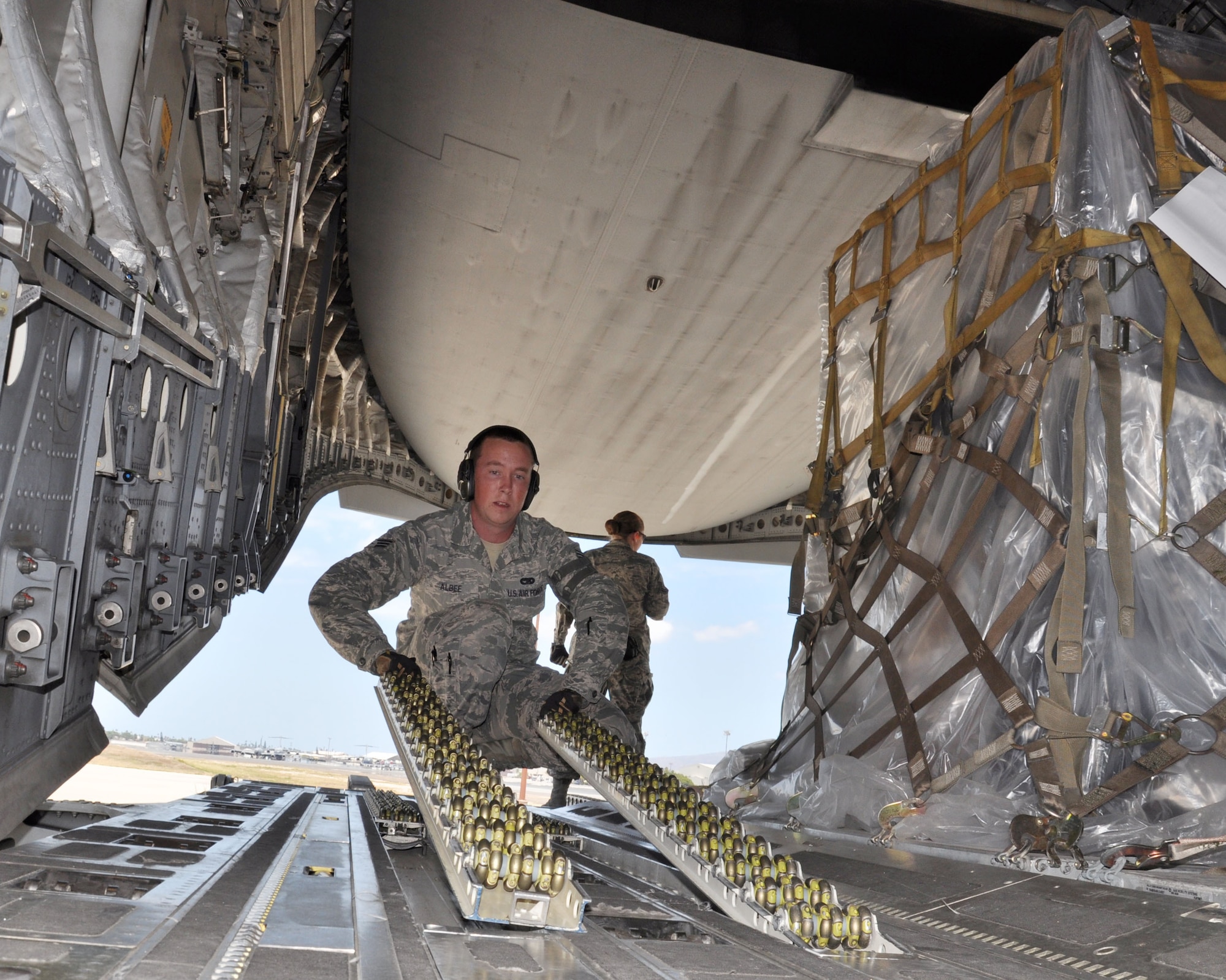 U.S. Air Force Senior Airman Travis Albee, aerial transportation specialist, helps load pallets onto a C-17 Globemaster III, Joint Base Pearl Harbor-Hickam, Hawaii, May 1, 2015. The pallets contain supplies for the Joint Air Component Coordination Element team who deployed to Uda Pao, Thailand to support the U.S. Agency for International Development's operations in Nepal. (U.S. Air Force photo by Maj. Ashley Conner/Released)