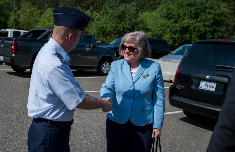 Col. Jeffrey DeVore welcomes Holly Petraeus, Consumer Financial Protection Bureau Senior Federal Executive Office of Servicemember Affairs, during a base visit May 4, 2015 at Joint Base Charleston - Weapons Station, S.C. Patraeus and South Carolina Attorney General Alan Wilson participated in a town hall meeting with Airmen and Sailors to educate them about their financial rights. DeVore is the JB Charleston commander. (U.S. Air Force photo/Senior Airman Jared Trimarchi)