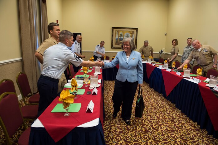 Holly Petraeus, Consumer Financial Protection Bureau Senior Federal Executive Office of Servicemember Affairs, greets Command Chief Master Sgt. Shawn Hughes during a table discussion with base leadership May 4, 2015 at Joint Base Charleston - Weapons Station, S.C. Patraeus and South Carolina Attorney General Alan Wilson participated in a town hall meeting with Airmen and Sailors to educate them about their financial rights. Hughes is the 437th Airlift Wing command chief. (U.S. Air Force photo/Senior Airman Jared Trimarchi)