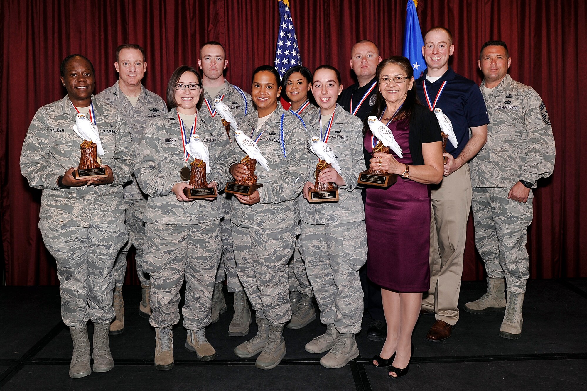 Col. Kevin Lamberth (left), the U.S. Air Force Academy's vice superintendent, and Chief Master Sgt. Max Grindstaff, the Academy's command chief, stand on stage with a group of 1st Quarter quarterly awards winners April 30, 2015 at the Falcon Club. These civilians were recognized for their outstanding efforts at the 1st Quarter Awards Luncheon here. (U.S. Air Force photo/Mike Kaplan)