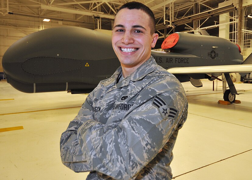 Senior Airman Kyle Struecker, 69th Maintenance Squadron crew chief, stands in front of an RQ-4 Block-40 Global Hawk on March 1, 2015 on Grand Forks Air Force Base, N.D. Struecker has been a crew chief for three years and helps maintains the Global Hawk assigned here. (U.S. Air Force photo by Senior Airman Xavier Navarro/released)
