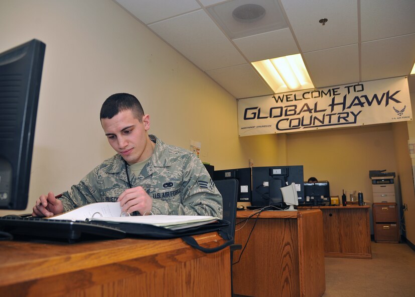 Senior Airman Kyle Struecker, 69th Maintenance Squadron crew chief, reads over his crew chief book on March 31, 2015, on Grand Forks Air Force Base, N.D. The crew chief book contains guidelines for forms, documentation and procedures. (U.S. Air Force photo by Senior Airman Xavier Navarro/released)