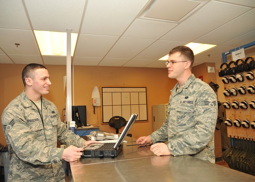 (right) Senior Airman James Quinn Jr., 69th Maintenance Squadron grounds systems technician,  helps (left) Senior Airman Kyle Struecker, 69th Maintenance Squadron crew chief, sign out a crew chief laptop at the 69th Maintenance support shop on Grand Forks AFB, N.D., March 31, 2015. The support shop gives maintainers the tools to work on the aircrafts. They are responsible for the accountability of the tools to ensure they are not missing. (U.S. Air Force photo by Senior Airman Xavier Navarro/released)