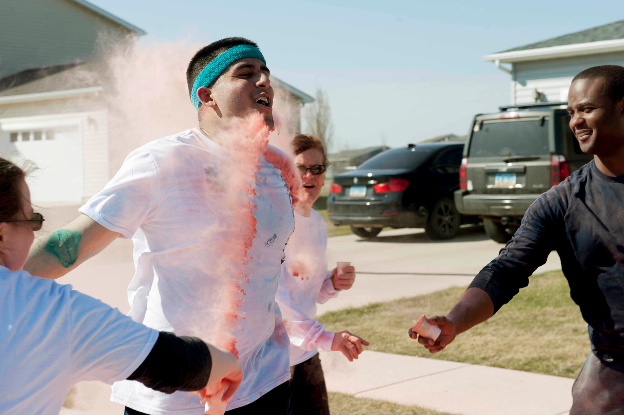 Airmen and their families run the Mighty Medic Meltdown 5K/10K race on Minot Air Force Base, N.D., April 23, 2015. The 5K/10K race began at the 5th Medical Group and trailed through base housing where stations with different colored dye was set up to be tossed on runners as they came by. (U.S. Air Force photo/Airman 1st Class Sahara L. Fales)