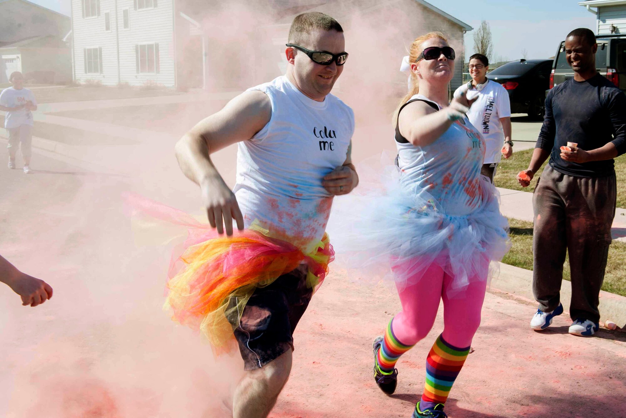 Airmen and their families run the Mighty Medic Meltdown 5K/10K race on Minot Air Force Base, N.D., April 23, 2015. The 5K/10K race began at the 5th Medical Group and trailed through base housing where stations with different colored dye was set up to be tossed on runners as they came by. (U.S. Air Force photo/Airman 1st Class Sahara L. Fales)