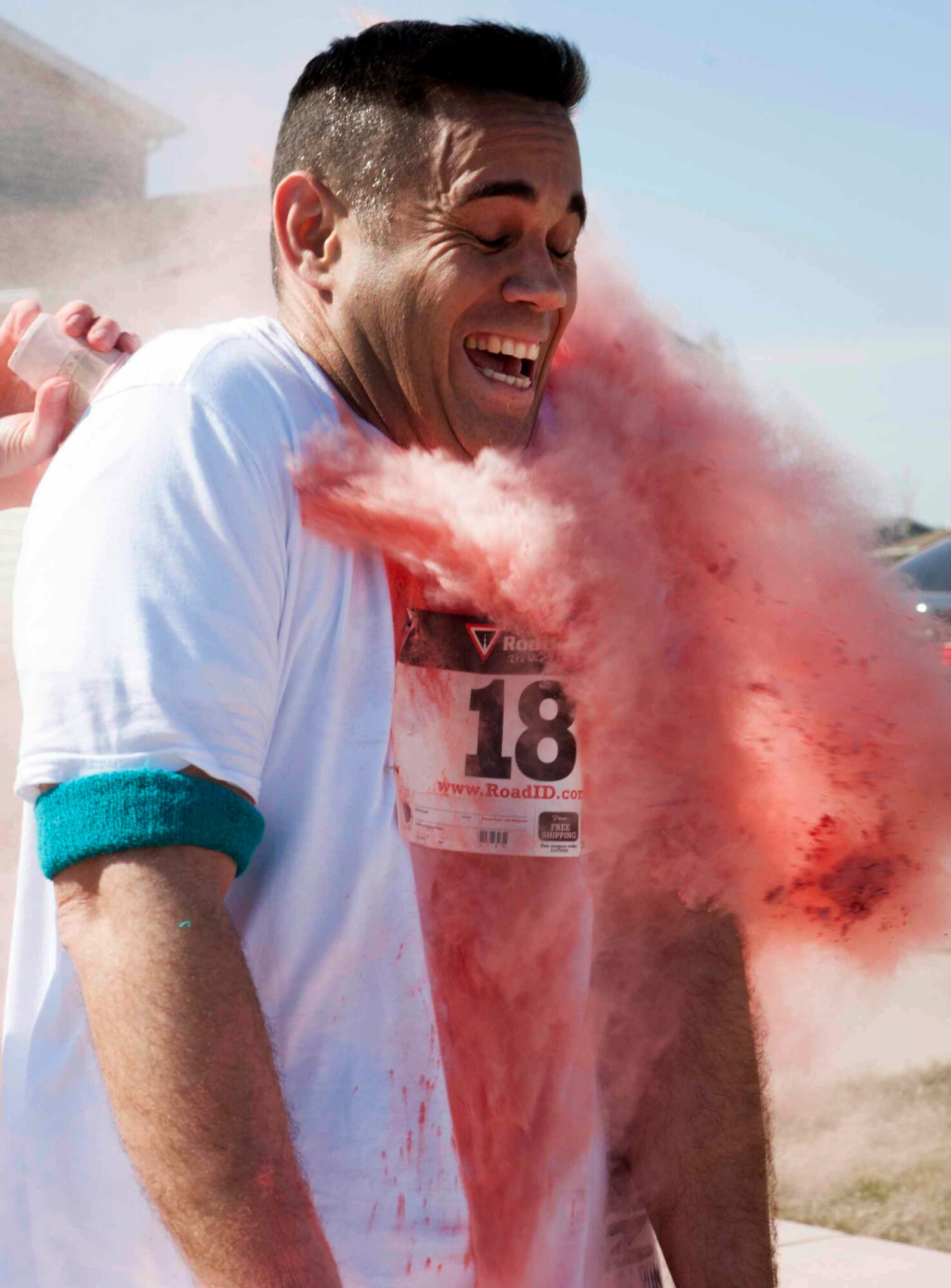 Airmen and their families run the Mighty Medic Meltdown 5K/10K race on Minot Air Force Base, N.D., April 23, 2015. The 5K/10K race began at the 5th Medical Group and trailed through base housing where stations with different colored dye was set up to be tossed on runners as they came by. (U.S. Air Force photo/Airman 1st Class Sahara L. Fales)