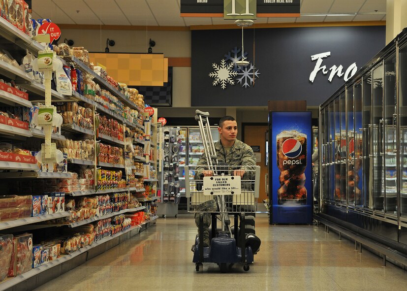 Senior Airman Kyle Struecker, 69th Maintenance Squadron crew chief, shops at the Commissary on Grand Forks Air Force Base, N.D., March 31, 2015. The Defense Commissary Agency provides groceries to miltary personnel, retirees and their families in a safe and secure shopping environment. (U.S. Air Force photo by Senior Airman Xavier Navarro/released)