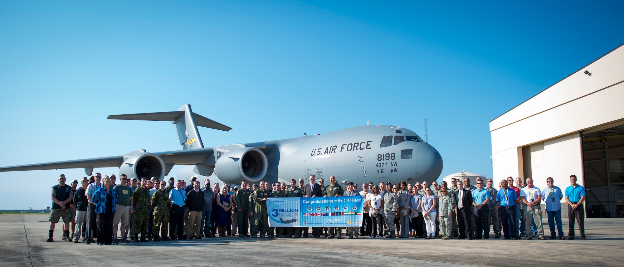 Personnel from the C-17 System Program Office, Boeing and aircrew members from the 437th Airlift Wing pose for a photo in front of a C-17 Globemaster III at Robins Air Force Base, Ga., May 5, 2015. During the flight to Joint Base Charleston, S.C., the C-17 logged the fleet's three-millionth flying hour. Upon arriving at JB Charleston, the aircraft taxied through a water arch provided by the 628th Civil Engineering Squadron's Fire Department and was met by senior leaders and JB Charleston civic leaders. (U.S. Air Force photo / Airman 1st Class Clayton Cupit)  