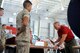 Bill Bockelman, 312th Training Squadron instructor, hammers his name tape onto a display board at the Louis F. Garland Department of Defense Fire Academy high bay on Goodfellow Air Force Base, Texas, May 1, 2015. The display honors the 20-year heritage of the fire academy with the names of past and present instructors. (U.S. Air Force photo by Tech. Sgt. Austin Knox/Released)