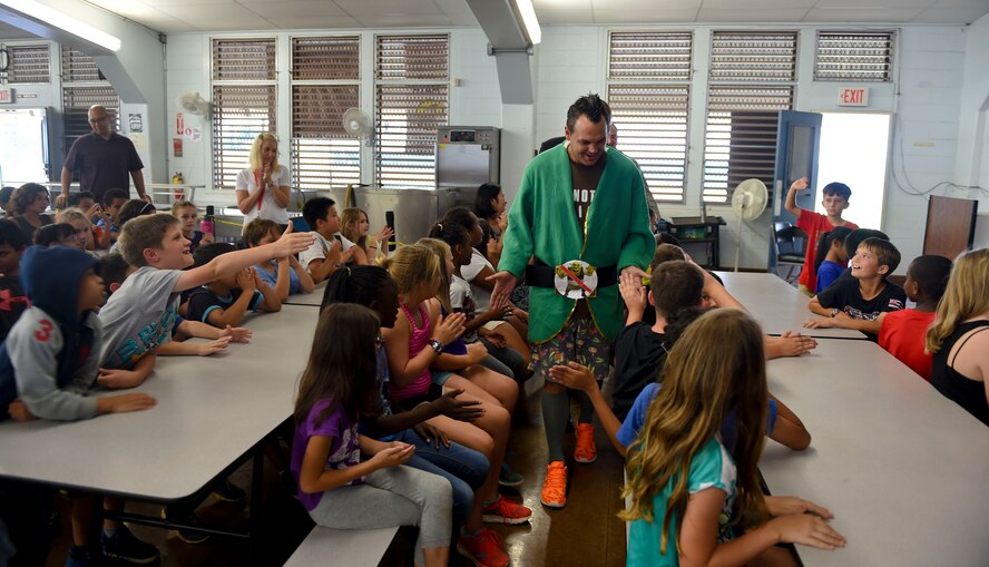 Tech. Sgt. Zachary Bolda, Pacific Air Forces Judge Advocate office NCOIC of operations & international law, greets students from Aliamanu Elementary School after performing a mock trial for Law Day May 1, 2015. Law Day is a time to reflect on the role of law in the foundation of the country. In recognition of the event, Airmen from Joint Base Pearl Harbor-Hickam entertained the crowd of students with a brief re-telling of Jack and the Beanstalk, followed by a mock trial to determine if any crimes had been committed during Jack’s journey up and down the beanstalk. (U.S. Air Force photo by Tech. Sgt. Terri Paden)