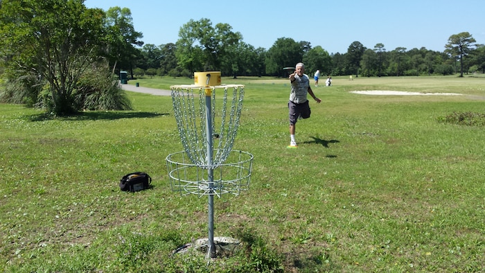 Tech. Sgt. Larry Kirk, a member of the Air National Guard's 144th Fighter Wing in Fresno, Ca., and an avid disc golf player, played the Disc Golf Course here at Joint Base Charleston, S.C., April 30, 2015. Disc golf is played much like traditional golf. Instead of a ball and clubs, however, players use a flying disc, or Frisbee®. Kirk is touring the U.S. for the fourth time attempting to play Disc Golf in 50 states in 50 days. (Courtesy photo)  