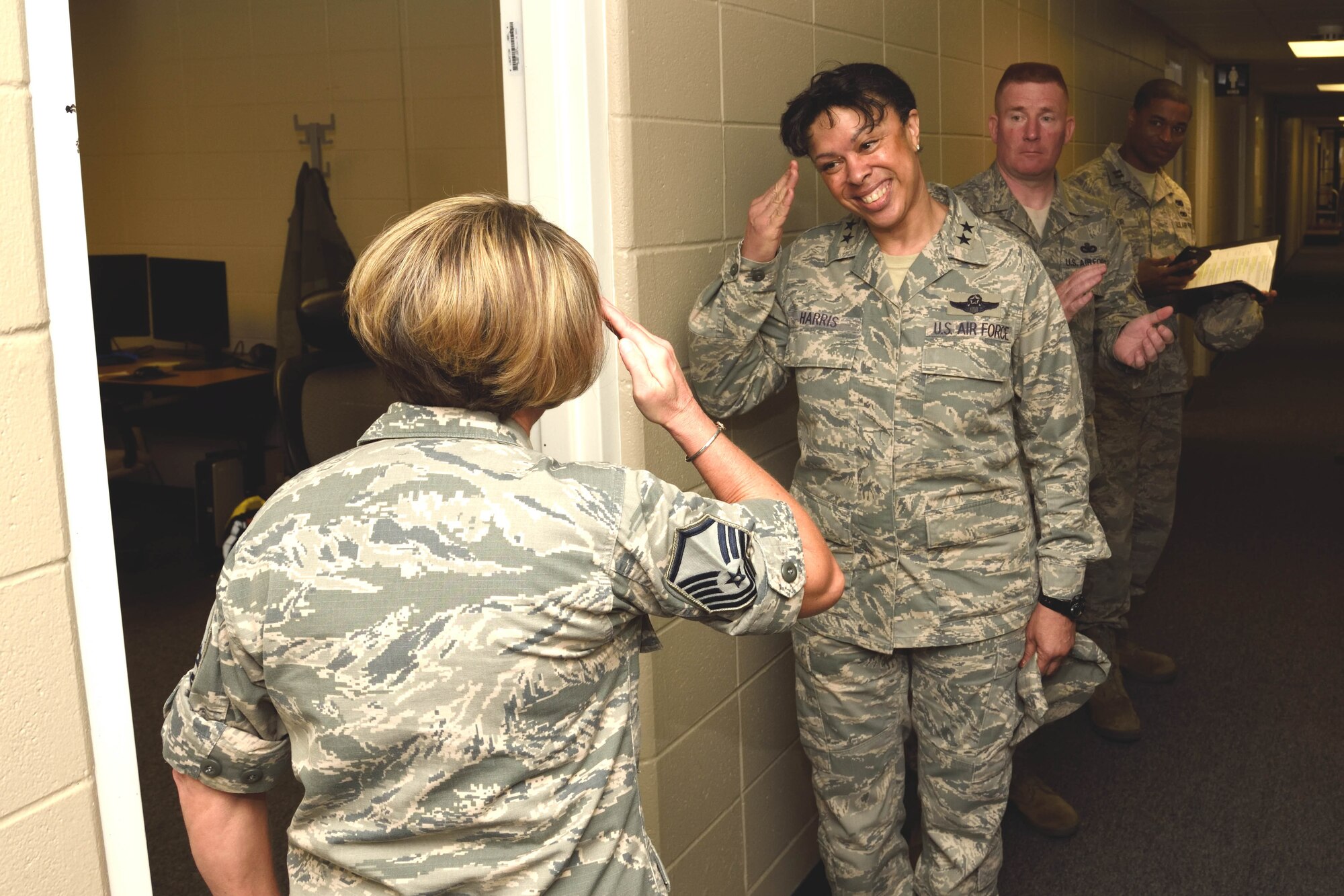 Maj. Gen. Stayce D. Harris, 22nd Air Force commander, returns the salute from Master Sgt. Spring Winters, 403rd Maintenance Group unit training manager, after giving her a 22nd AF commander’s coin May 3, 2015, for receiving the military individual volunteer of the year recently at the 32nd Annual City of Biloxi, Mississippi Volunteer Recognition ceremony. Harris visited the 403rd Wing at Keesler Air Force Base, Mississippi, May 1-4, 2015, to interact with the Citizen Airmen and gain a better understanding of the organization and the wing’s mission. (U.S. Air Force photo/Tech. Sgt. Ryan Labadens)