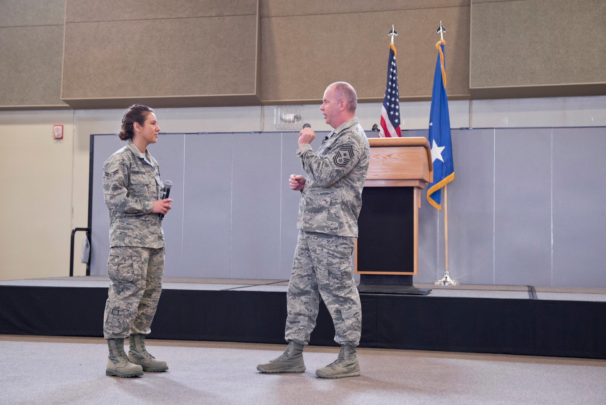 The Command Chief Master Sgt. of the Air National Guard (CCM ANG), Chief Master Sgt. James W. Hotaling (right) presents Airman 1st Class Jessica Thomerson (left), 132d Geospatial Intelligence, with his coin during the 132d Wing, Des Moines, Iowa May Off-Site Resiliency Event held at the Valley Community Center, West Des Moines, Iowa on Saturday, May 2, 2015; Thomerson is receiving Hotaling’s coin because she shared her stories of Basic Military Training at Lackland Air Force Base, San Antonio, Texas with the group (per Hotaling's request).  The Director of the Air National Guard (DANG), Lt. Gen. Stanley E. Clarke III, is also in attendance, which marks the first time in history that both the DANG and CCM ANG visit an ANG wing together.  (U.S. Air National Guard photo by Tech. Sgt. Linda K. Burger/Released)