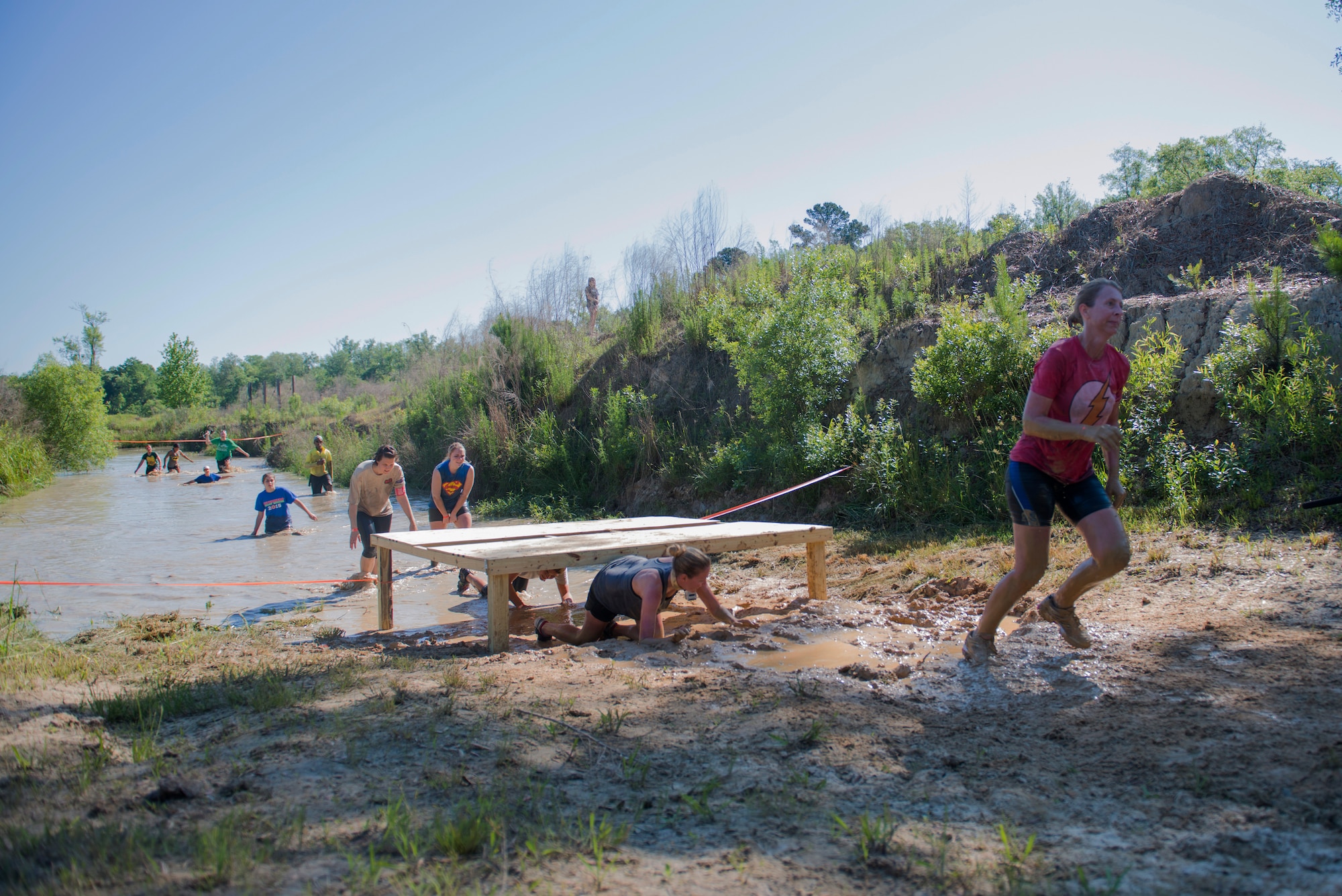 Runners rush to finish the last obstacle of the 2015 Moody Mudder May 2, 2015, in Ray City, Ga.  Moody Airmen and community members attended a barbecue following the end of the run. (U.S. Air Force photo by Airman 1st Class Dillian Bamman/Released)