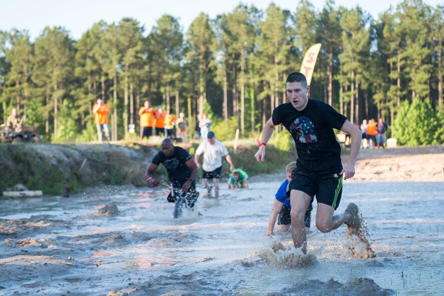 U.S. Air Force Maj. Jonathan Czarney, 23d Contracting Squadron commander, sprints through the starting mud pit during the 2015 Moody Mudder May 2, 2015, in Ray City, Ga. More than 400 Moody Airmen and community members participated in the annual run.
(U.S. Air Force photo by Airman 1st Class Dillian Bamman/Released)
