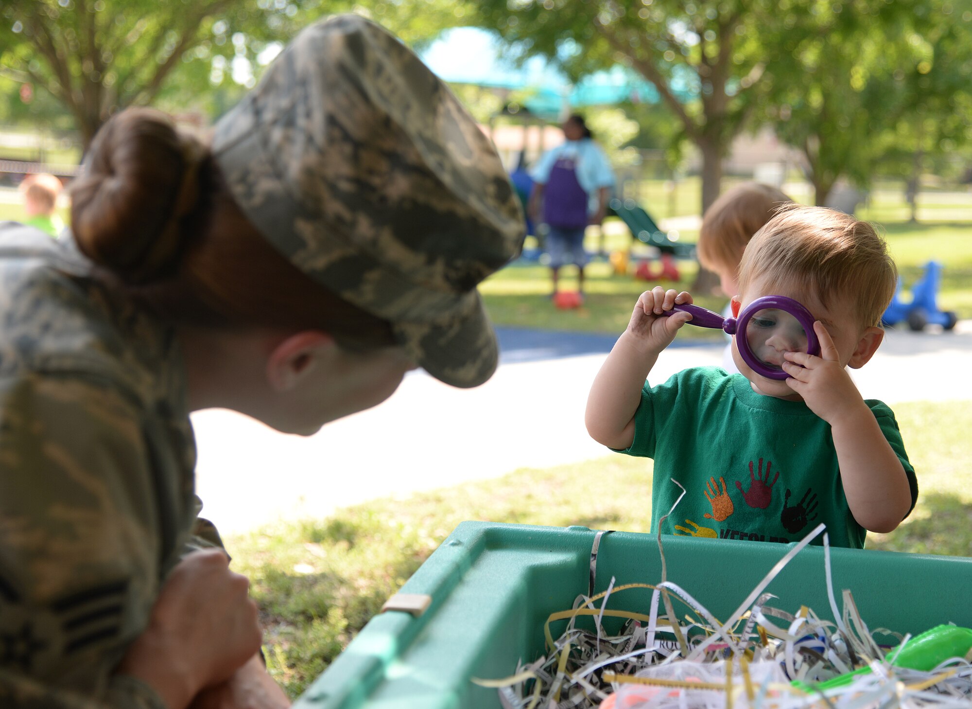 Michael Polen, son of Senior Airman Mandy Polen, 81st Medical Support Squadron clinical research laboratory technician, looks at his mom through a magnifying glass at the Month of the Military Child Parent Day at the Keesler Child Development Center, April 30, 2015, Keesler Air Force Base, Miss. The CDC invited parents to participate in different activities with their children to celebrate the end of Month of the Military Child. (U.S. Air Force photo by Senior Airman Holly Mansfield)