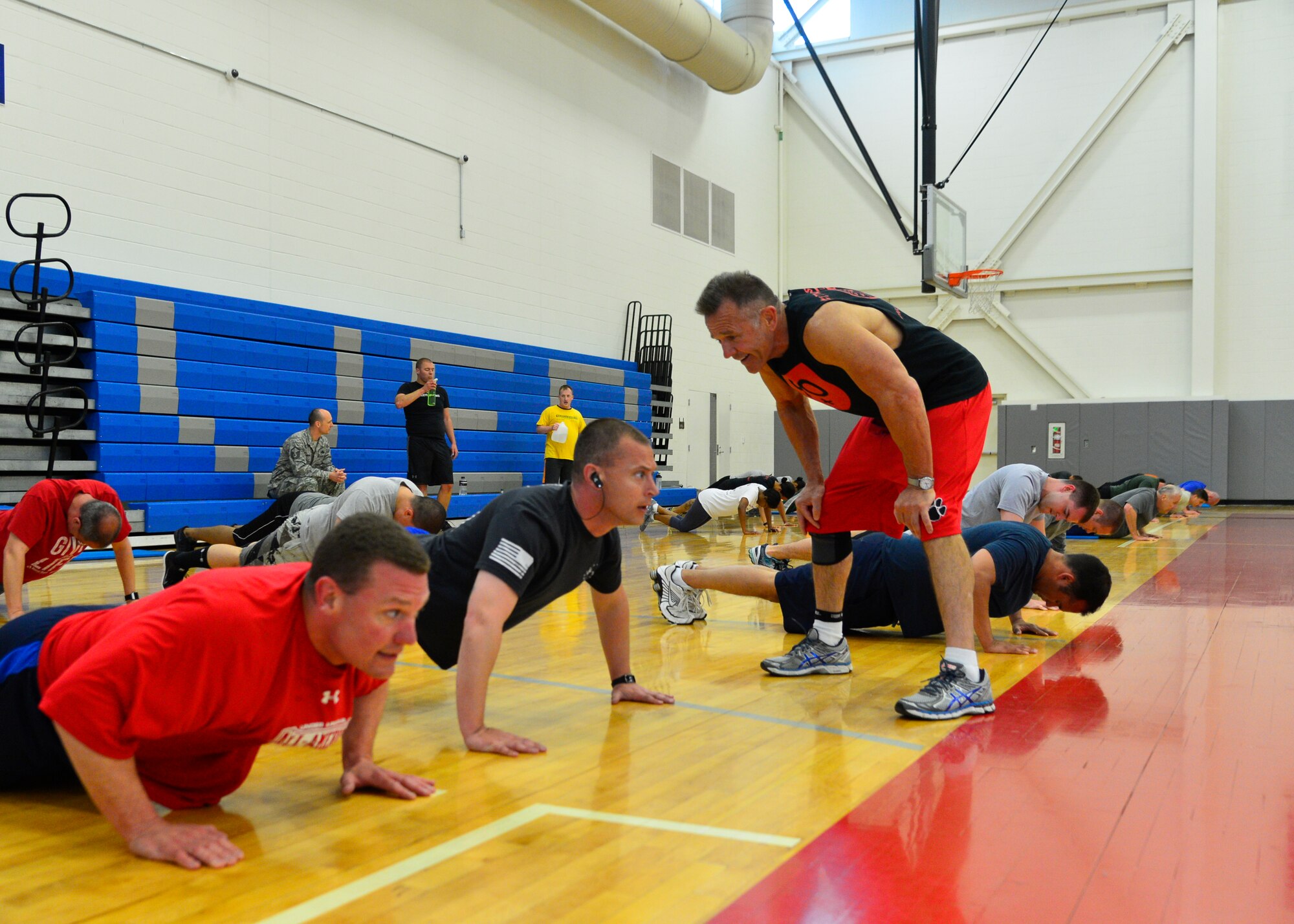 John Walters, 436th Force Support Squadron fitness program manager, right, motivates Master Sgt. Corey Diluzio, 712th Aircraft Maintenance Squadron aircraft overhaul supervisor, center, and Master Sgt. Joey Therrien, 512th Maintenance Squadron engine repair supervisor, left, during a “90+” workout April 29, 2015, at the Fitness Center on Dover Air Force Base, Del. Walters, who created the old “90n90” program, now coaches more than 100 Airmen through his new “90+” program. (U.S. Air Force photo/Airmen 1st Class William Johnson)