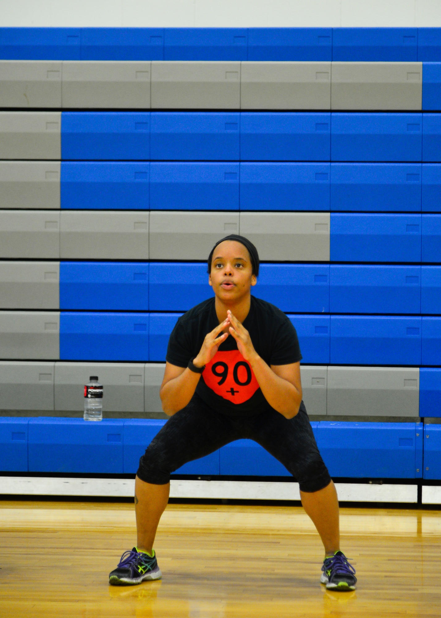 U.S. Navy Petty Officer 1st Class Velinda Jennings, Armed Forces Medical Examiner System, performs air squats during a “90+” workout April 29, 2015, at the Fitness Center on Dover Air Force Base, Del. The “90+” program replaced the “90n90” program and has more than 100 active participants. (U.S. Air Force photo/Airman 1st Class William Johnson)