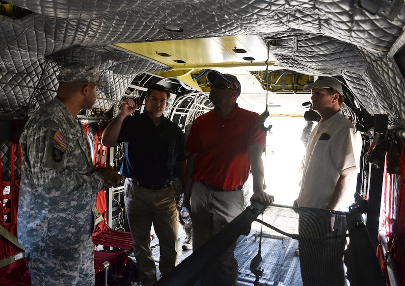 SOTO CANO AIR BASE, Honduras – A 1-228 Aviation Battalion crew chief explains the capabilities of the CH-47 Chinook to U.S. Ambassador to Honduras James Nealon (right),  Congressman Marc Veasey (center right), representing Texas’ 33rd District, and Congressman Austin Scott (center left), representing Georgia’s 8th District, during a congressional delegation visit May 4, 2015, at Soto Cano Air Base, Honduras. A versatile airframe, the CH-47 Chinook provides a broad range of support to U.S. and partner nation efforts to stabilize the Central American region. (U.S. Air Force photo by Staff Sgt. Jessica Condit)